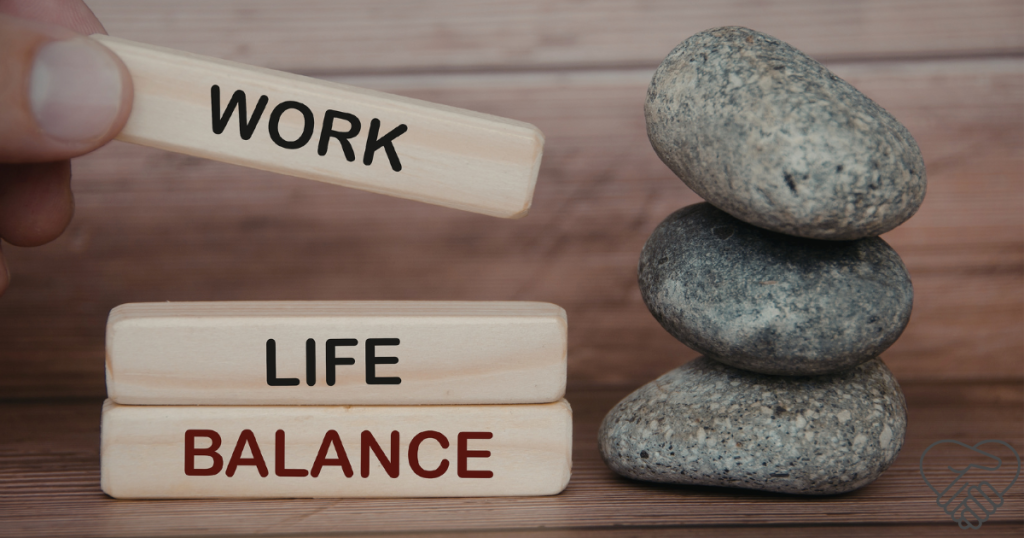 A hand arranging wooden blocks to spell out "Work", "Life", and "Balance," symbolizing the challenge of maintaining boundaries while caring for a loved one with dementia.