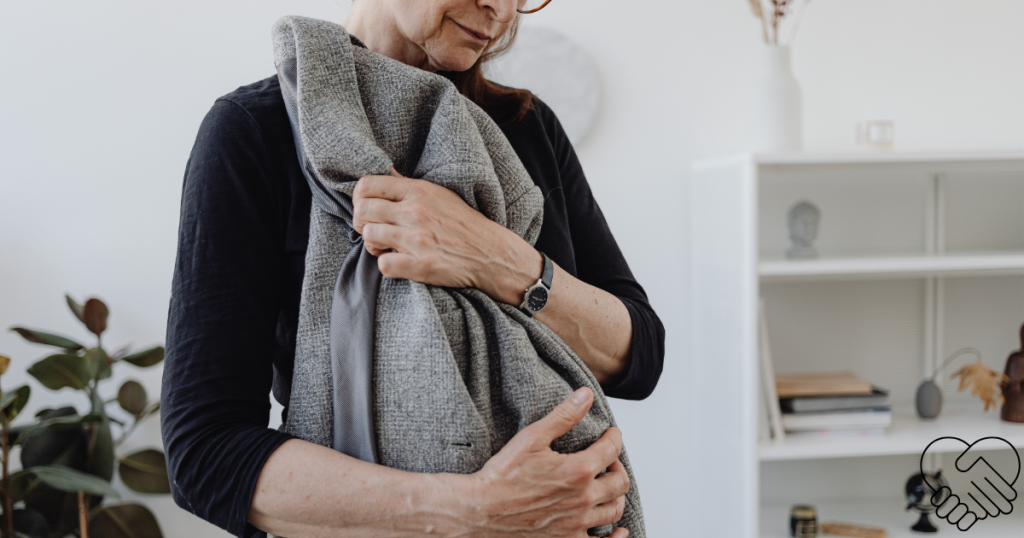 A poignant close-up of an elderly woman tenderly holding and hugging her late husband's coat, symbolizing the enduring connection and the process of grieving a loved one with dementia.