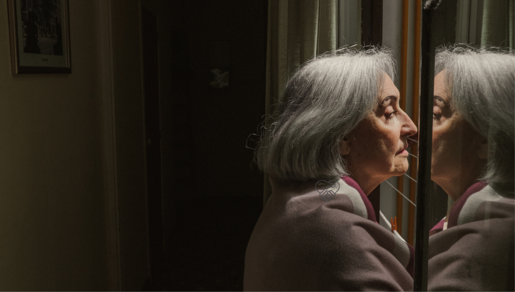 CREATING SAFETY AND PREVENTING ACCIDENTS IN DEMENTIA Elderly woman with dementia walking carefully at home while a family caregiver supports her to prevent falls.