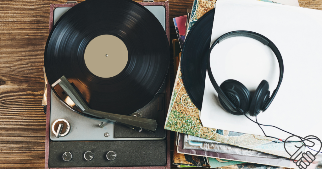 Music Therapy for Dementia: How Music Improves Memory and Mood A vintage record player, a vinyl record, and modern headphones sitting on a wooden table, representing music therapy for a loved one with dementia.